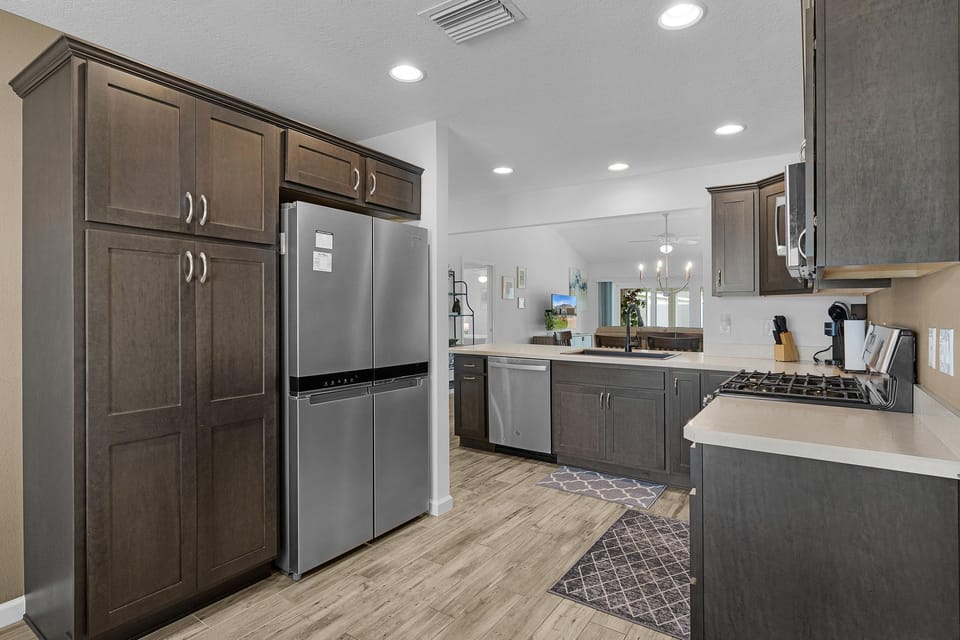 Your fully equipped kitchen features modern stainless steel appliances, plenty of cabinet space, and a gas stove perfect for preparing home-cooked meals during your stay.