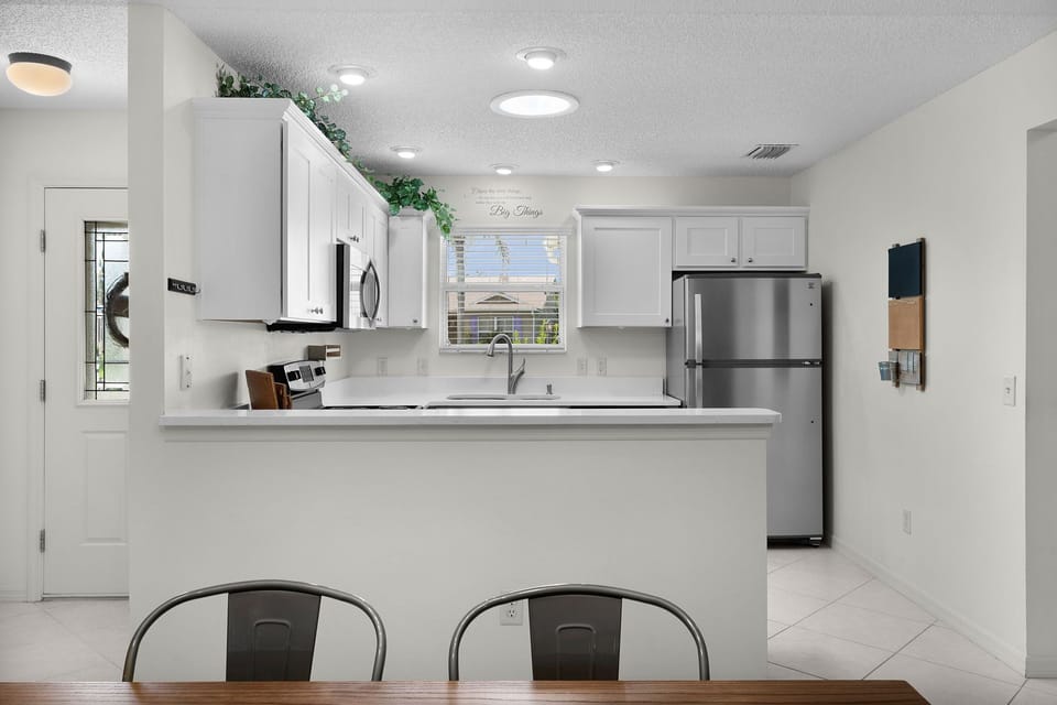 Your bright open kitchen offers stainless steel appliances, plenty of counter space, and a cheerful breakfast bar—perfect for morning coffee or casual meals together.