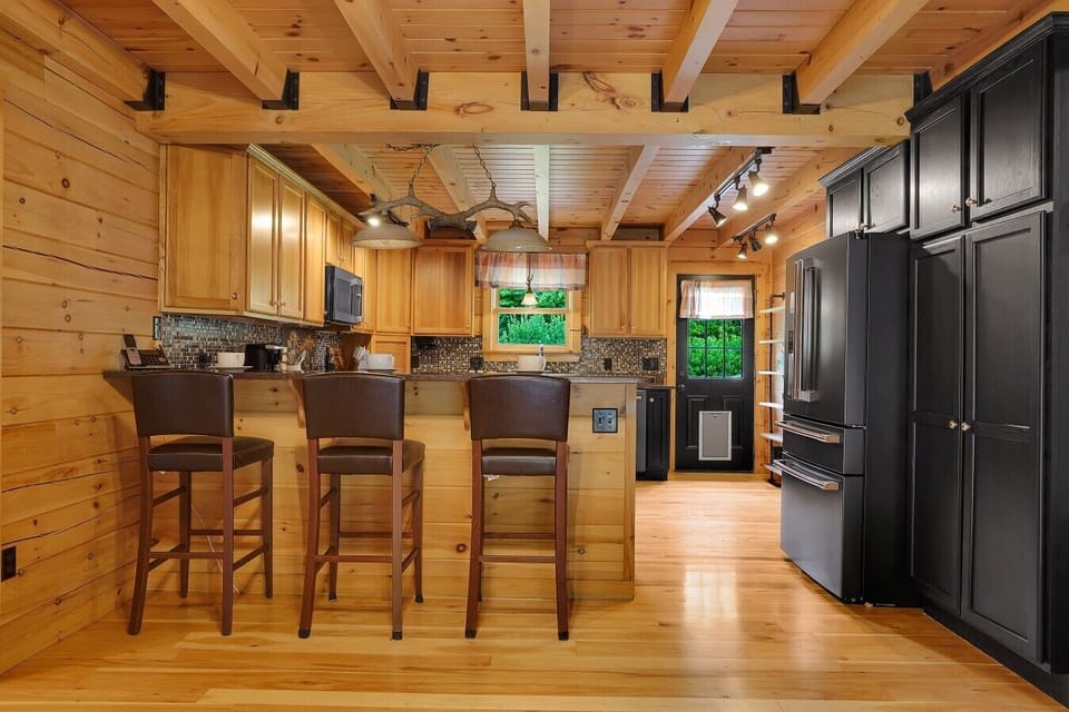 Kitchen with Bar Seating for 3, shared bathroom access from kitchen.