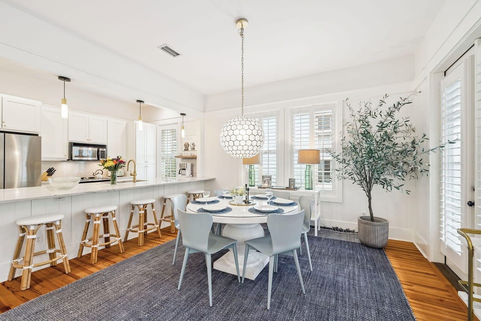 Your bright open kitchen and dining space welcomes you with modern white cabinetry, stylish pendant lighting, and a cozy dining nook perfect for memorable meals.