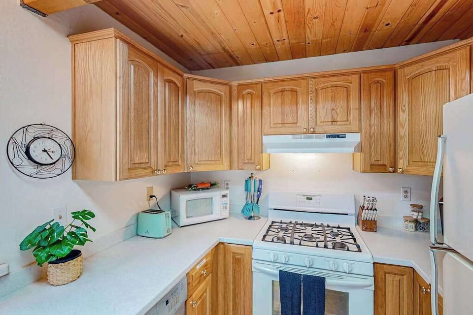 The well-equipped kitchen at Forest Retreat offers rustic decor, creating a cozy atmosphere for memorable meals in Arnold, CA.