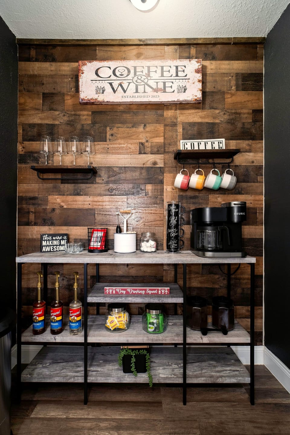 Cozy rustic coffee bar with stocked essentials and stylish wood accent wall