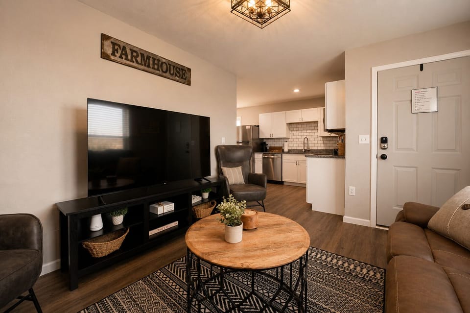 Cozy farmhouse-style living room with smart TV and open modern kitchen