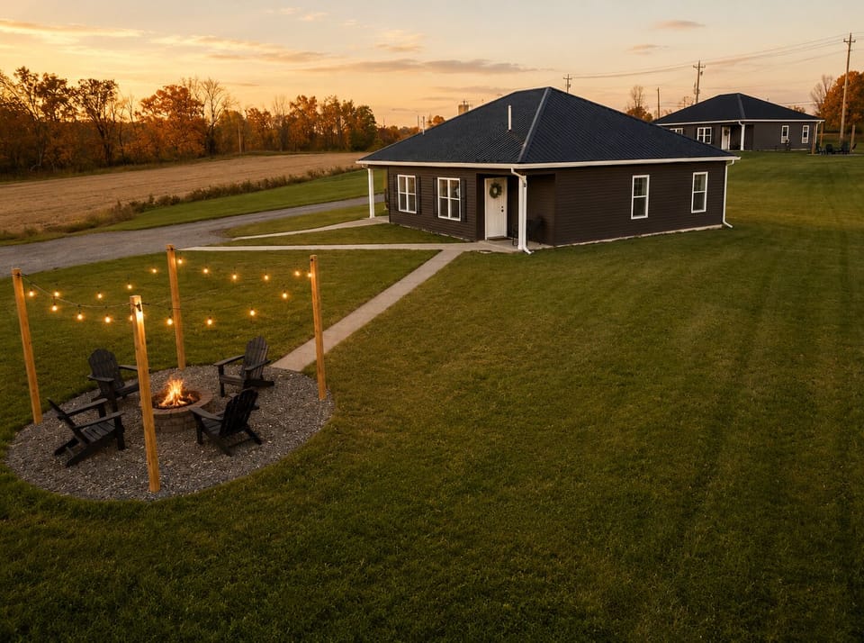 Sunset views, spacious lawn, and a cozy fire pit under string lights
