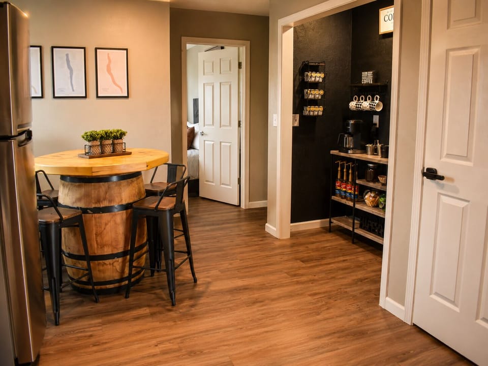 Cozy dining nook with barrel table and fully stocked coffee bar