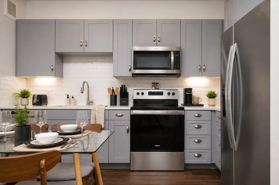 Fully equipped kitchen with sleek finishes and open dining space.