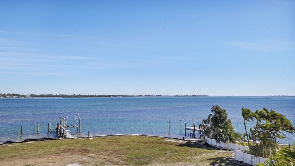Peaceful bayfront views with private docks and tropical coastal charm