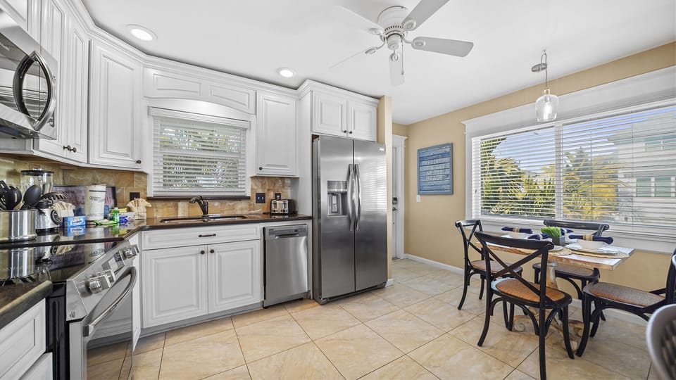 Bright kitchen with stainless appliances and sunny breakfast nook