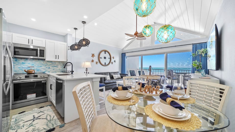 Bright oceanview condo with vaulted ceilings, stylish decor, and open living