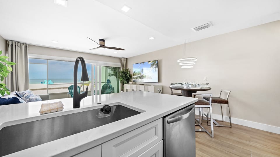 Modern coastal condo with open kitchen and stunning ocean-view balcony