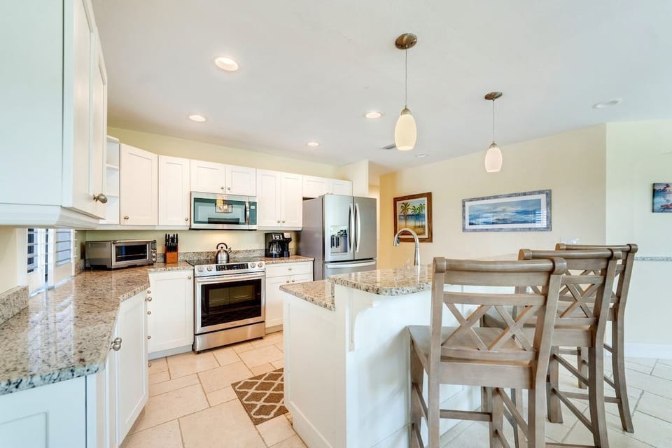 A third view of the dining area and kitchen highlights the cooking space.