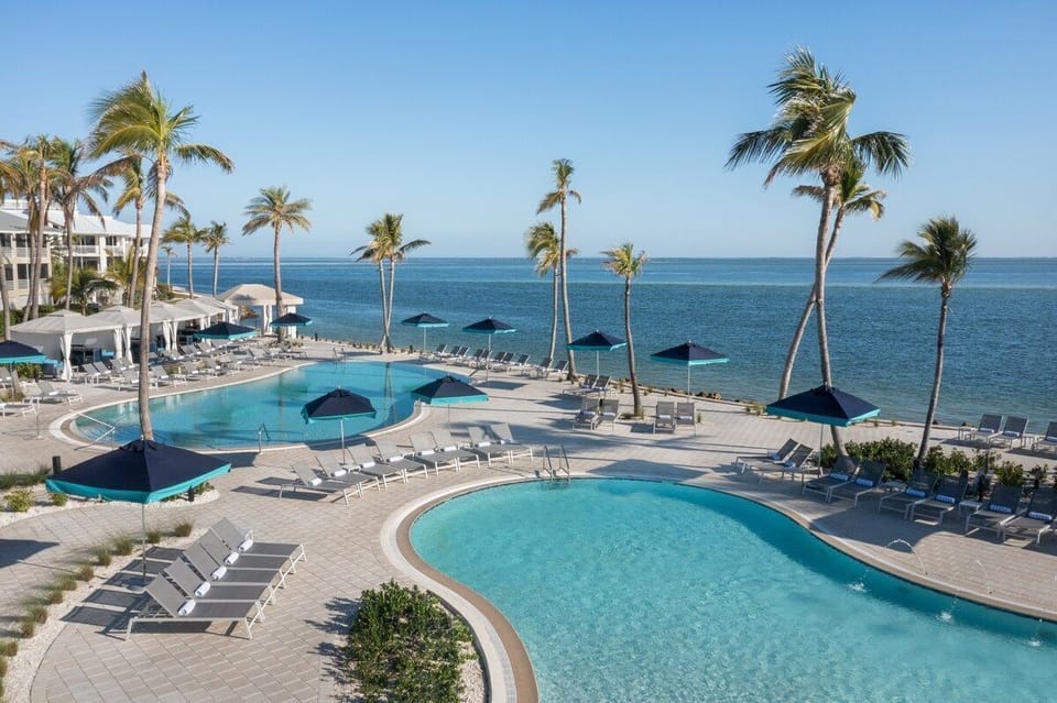 Get a bird's-eye look at the pool complex, its blue water framing the palm-lined resort grounds below.