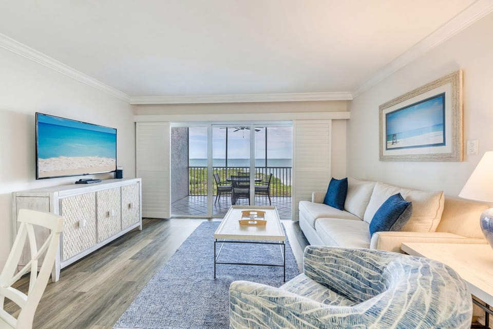 Unwind on the couch across from the TV, with a chair and coffee table nearby.
