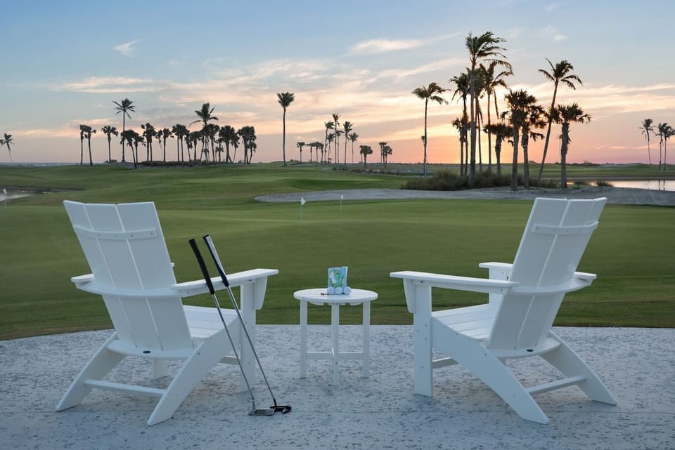 Settle into an Adirondack chair beside The Clutch golf course, greens stretching out under swaying palms.