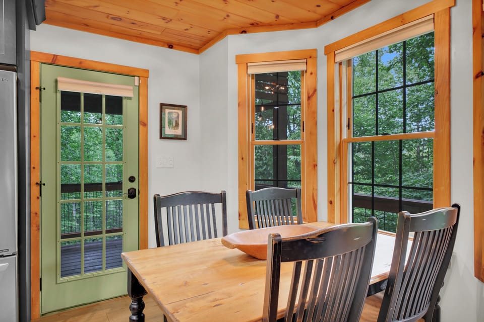 Breakfast in the corner nook with windows on two sides, then out the green door to the deck when the coffee is gone.