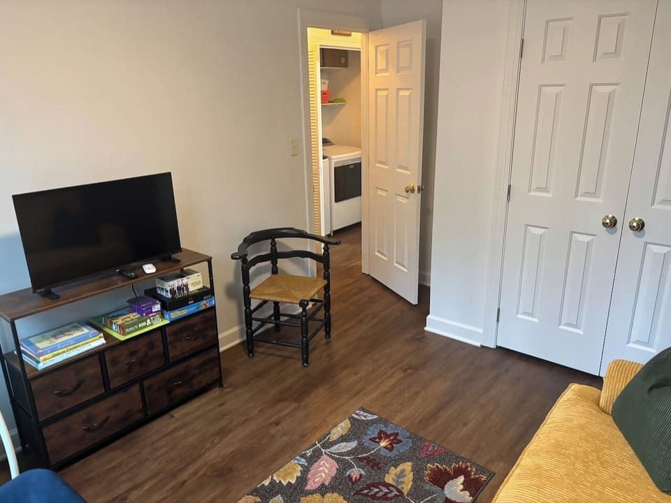 A comfortable room with a sofa and TV