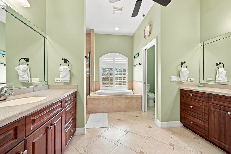 The ensuite bath features dual vanities, a soaking tub, and a separate walk-in shower—providing plenty of room to start and end each day in comfort.