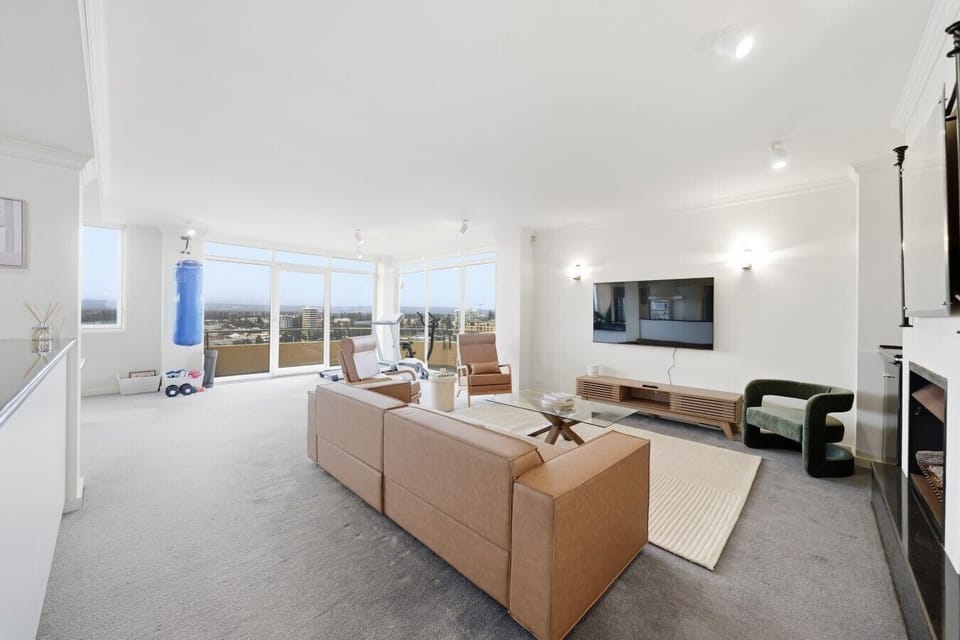 Relaxed lounge space with city and coastline views.