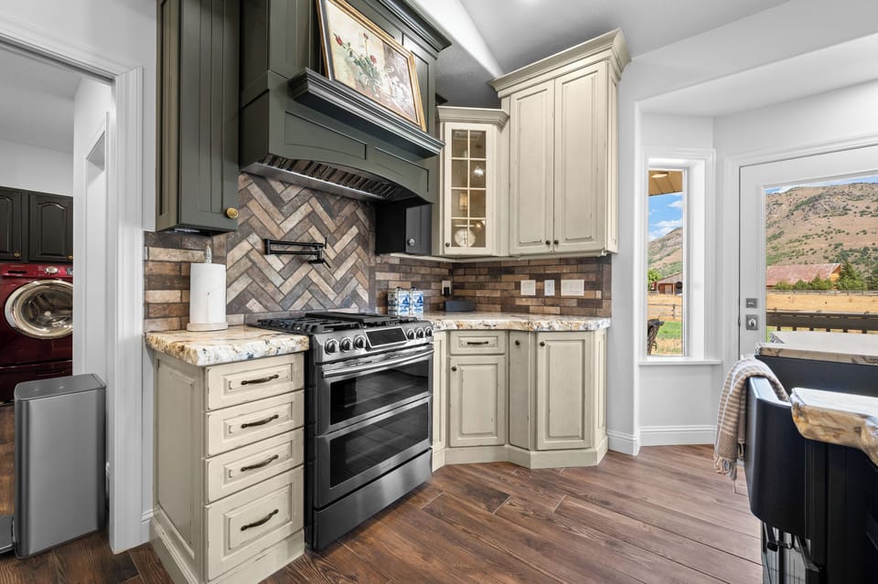 The kitchen’s range, expansive cooking surface, and richly textured finishes create an impressive setting for home-cooked meals.