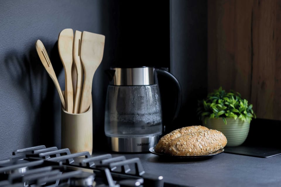 A close up of the kitchen featuring a coffee machine and cooking essentials. Everything is ready for your daily routine.