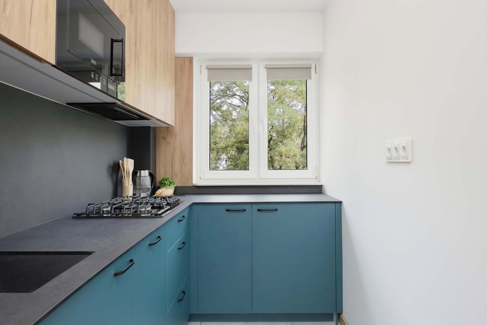 A modern kitchen with ample countertop space and natural light. Perfect for preparing breakfast or dinner.
