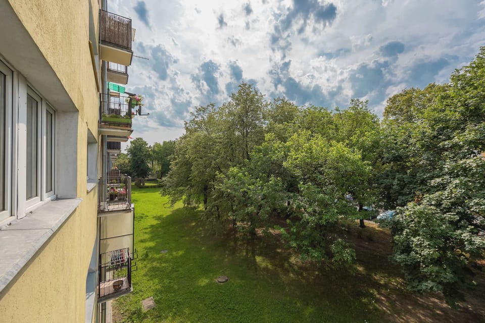 A pleasant view of the greenery outside the apartment. Enjoy a peaceful setting during your stay.