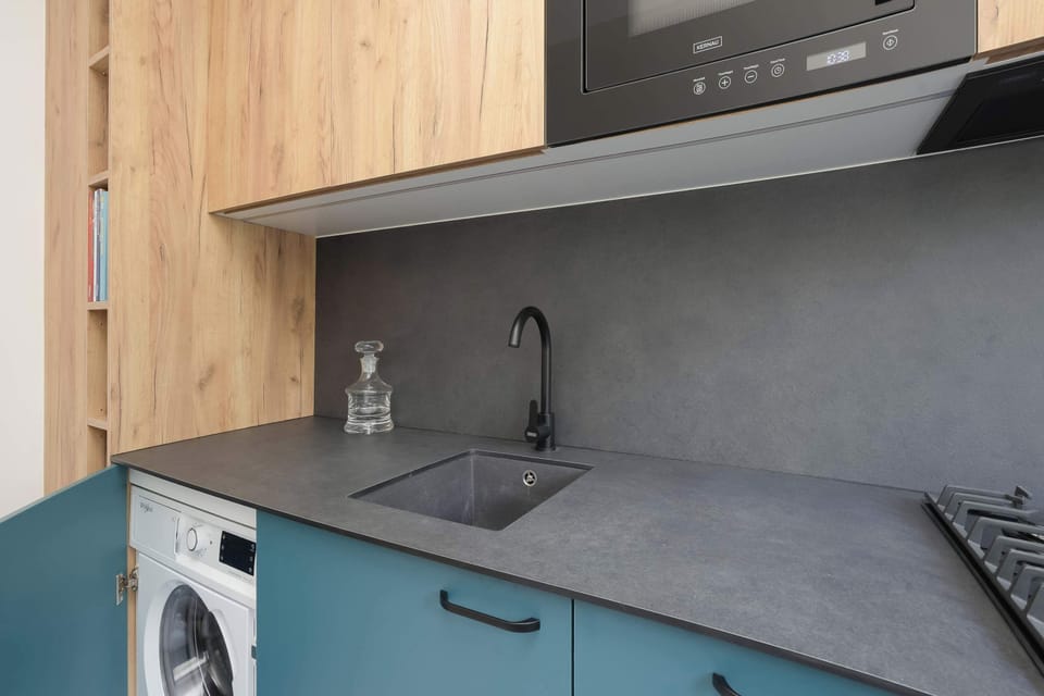 A functional kitchen with modern appliances and practical storage. Designed for convenient everyday cooking.