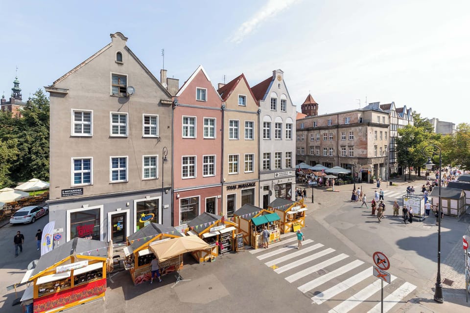 A panoramic view of the historic town center with elegant old buildings. The vibrant surroundings are perfect for exploring on foot.