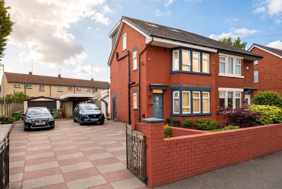 Detached red brick home with driveway parking for the whole group