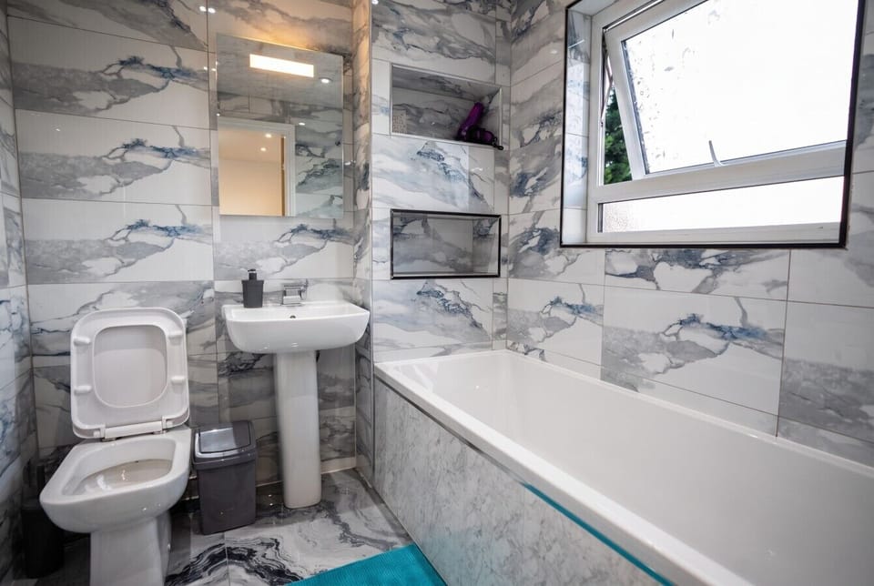 Marble tiled bathroom with full tub for a relaxing soak