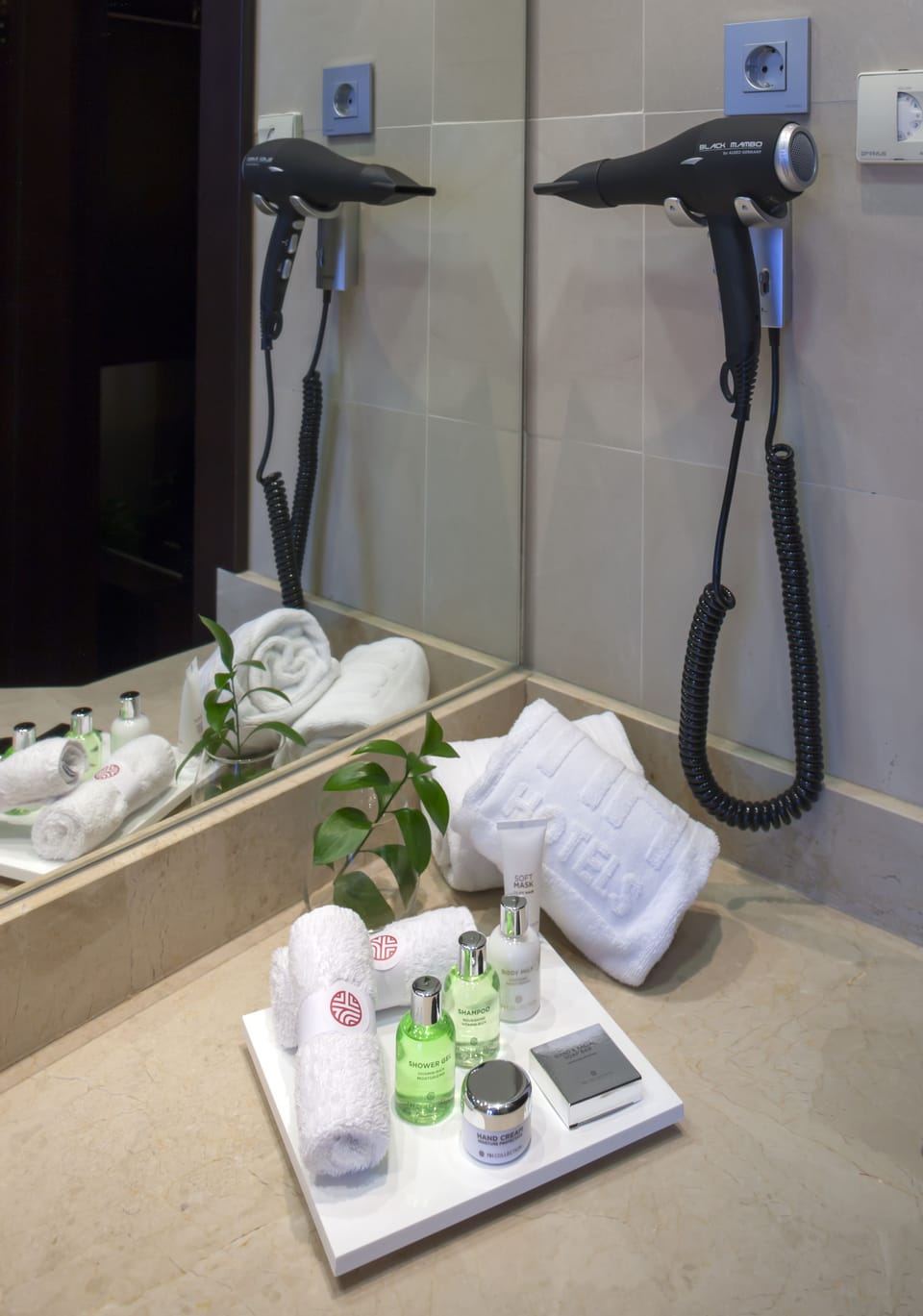 Deep soaking tub, rainfall showerhead, eco-friendly toiletries