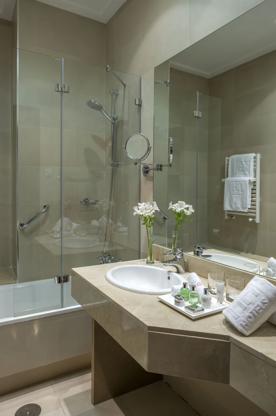 Deep soaking tub, rainfall showerhead, eco-friendly toiletries