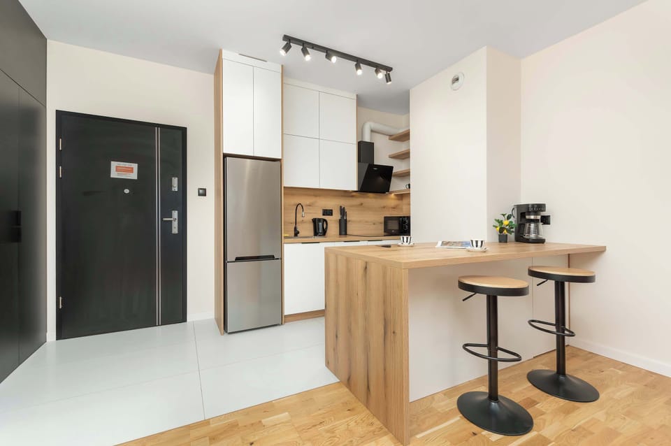 Modern kitchen with a breakfast island, bar seating, and contemporary cabinetry.