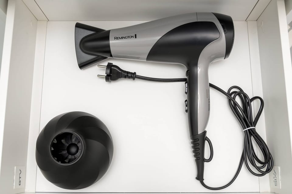 Hairdryer provided for guests in the bathroom.