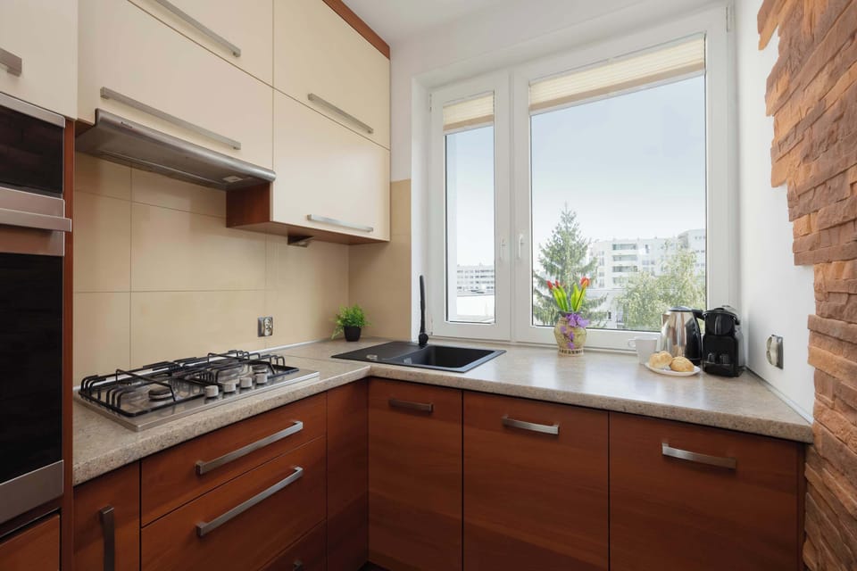 Functional kitchen with built-in oven, stovetop, microwave, and modern cabinetry.