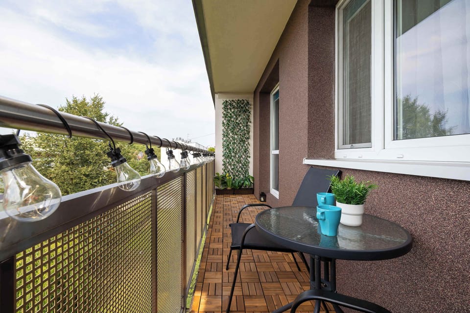A cozy balcony furnished with a small table and chairs. Relax outdoors while taking in the fresh air and surrounding views.