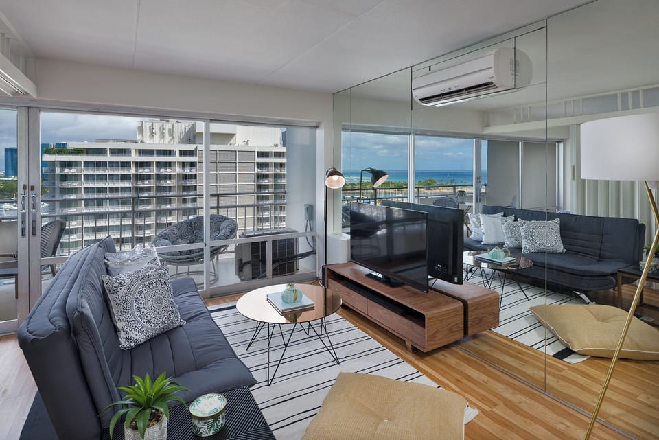 Living area with queen futon sofa bed and flat screen TV to relax and unwind