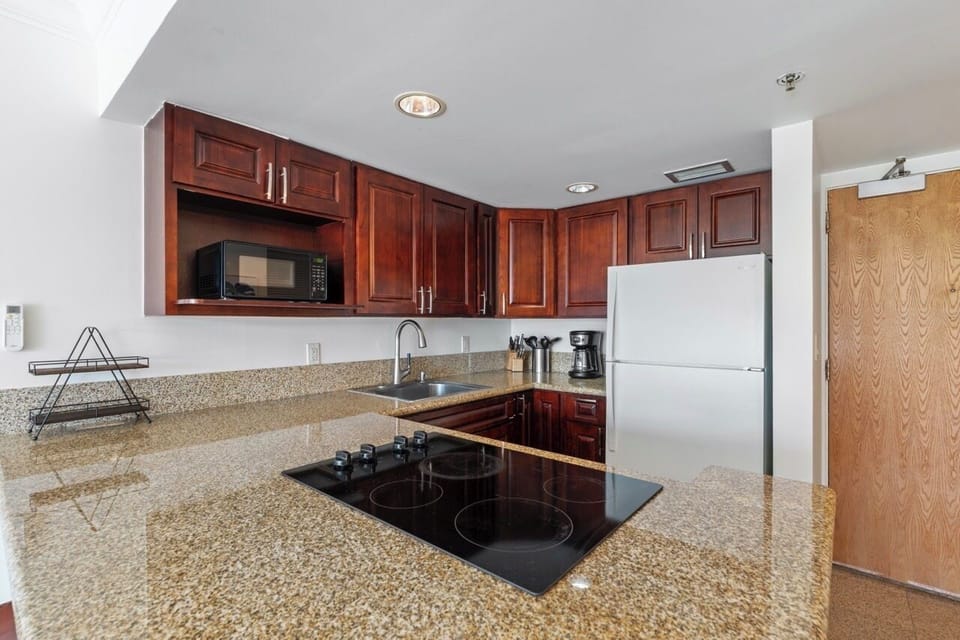 Full kitchen with range/oven, microwave, refrigerator/freezer and small appliances, granite counter tops
