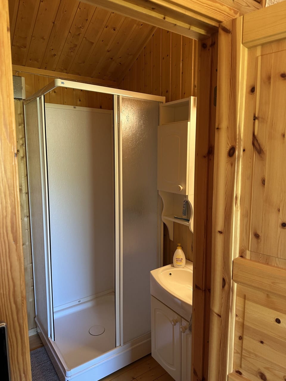 The shower and a sink is in a room separate from the toilet - water due to availability by pump