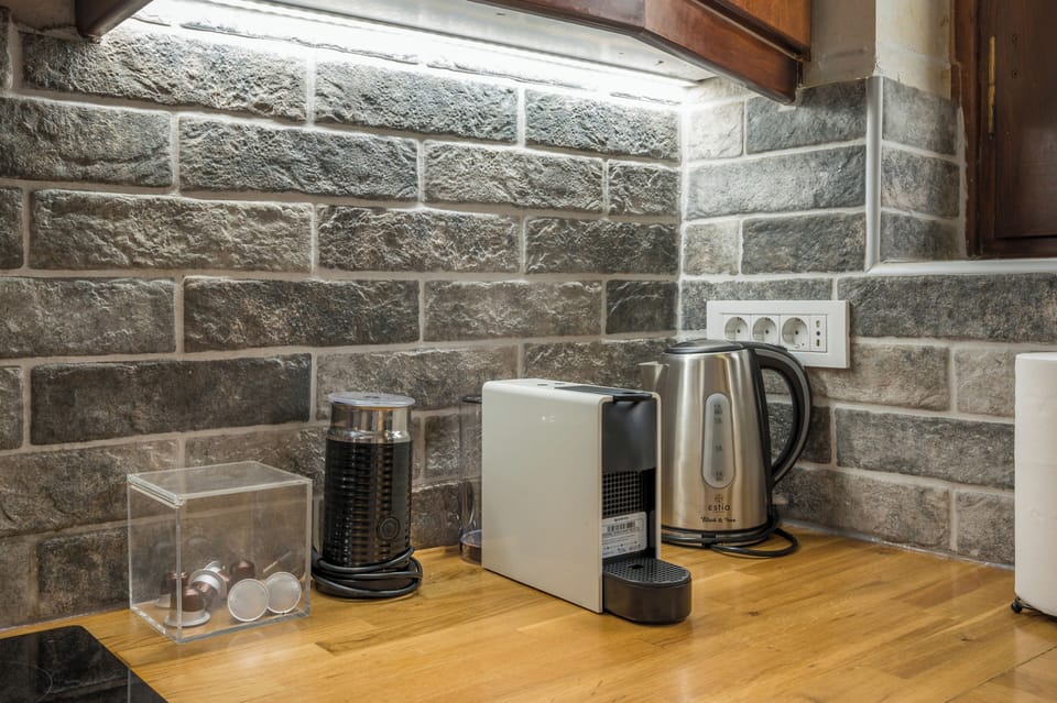 Start your mornings right with your own coffee station, complete with a sleek espresso machine and electric kettle ready for your favorite brew.