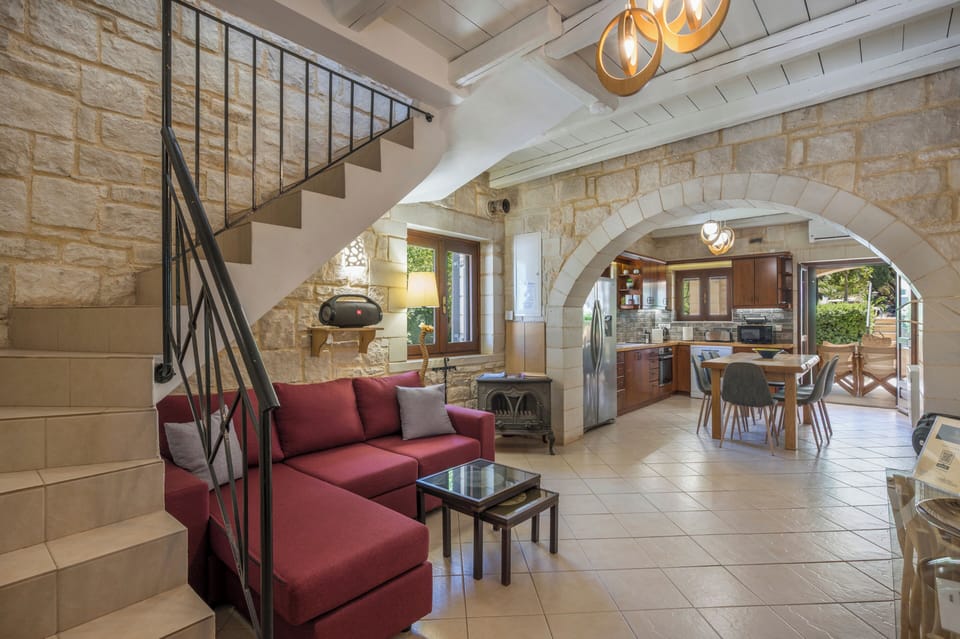 Sunlight pours through rustic stone archways, warming this open-plan space where old-world charm meets modern comfort. Fully equipped kitchen, cozy lounge, and private terrace with Mediterranean breeze.