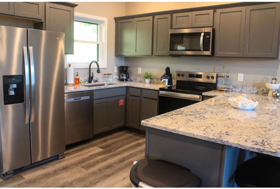 Your fully equipped kitchen features modern stainless appliances, granite countertops, and plenty of space for preparing meals together during your stay.