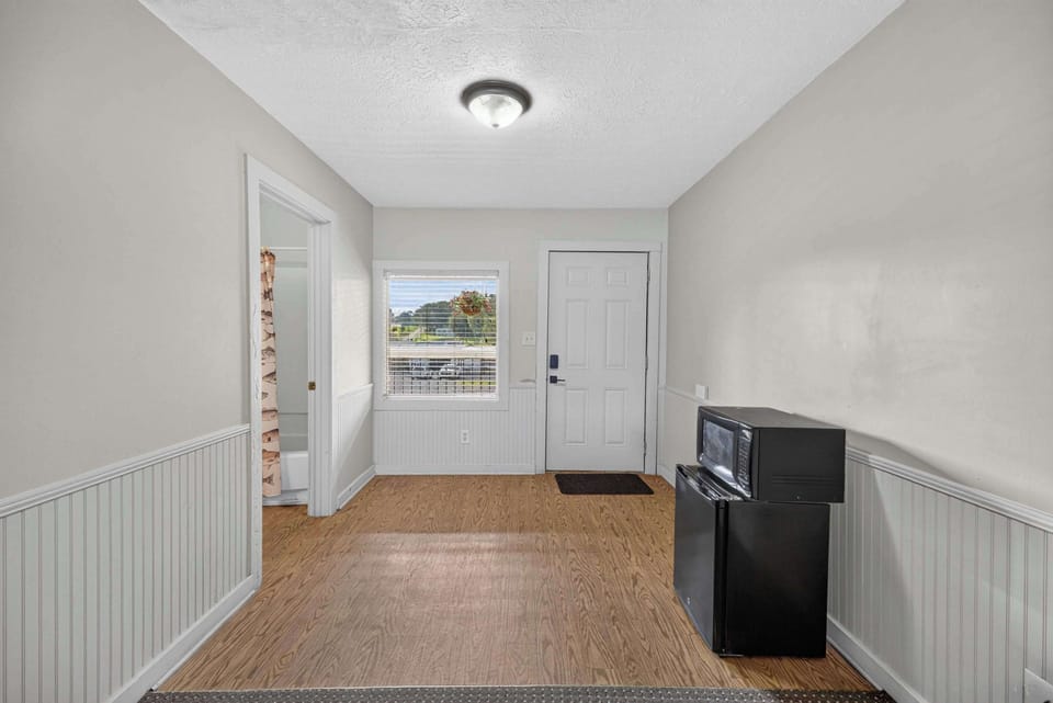 Entrance to your unit with a mini fridge and microwave