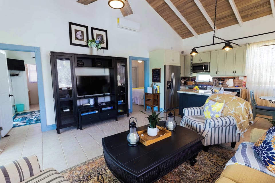 Open-concept space with entertainment center and TV
