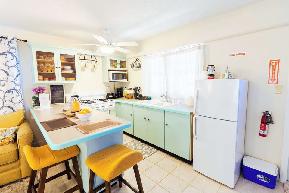 Full kitchen with bar seating and fridge