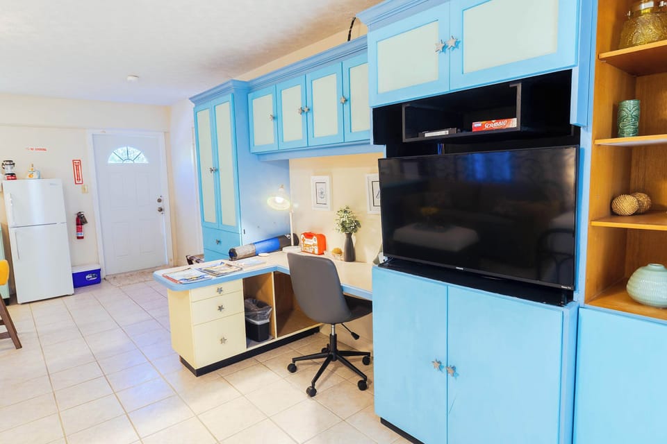 Full kitchen with dedicated desk area and TV