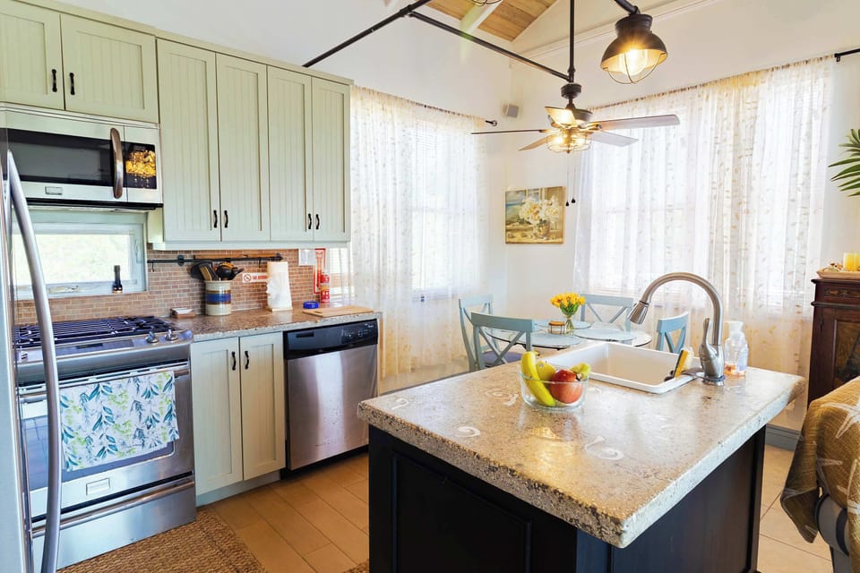 Stainless steel appliances with granite island and gas range