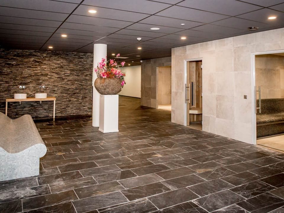 Glide through spacious wellness areas with stone textures and calm.