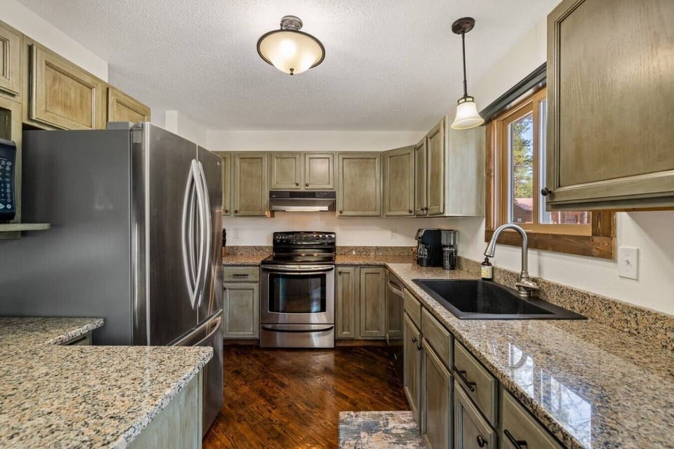 The stylish minimalist kitchen features a clean, organized design with a pleasing aesthetic, creating a beautiful and functional space for preparing meals and gathering together.