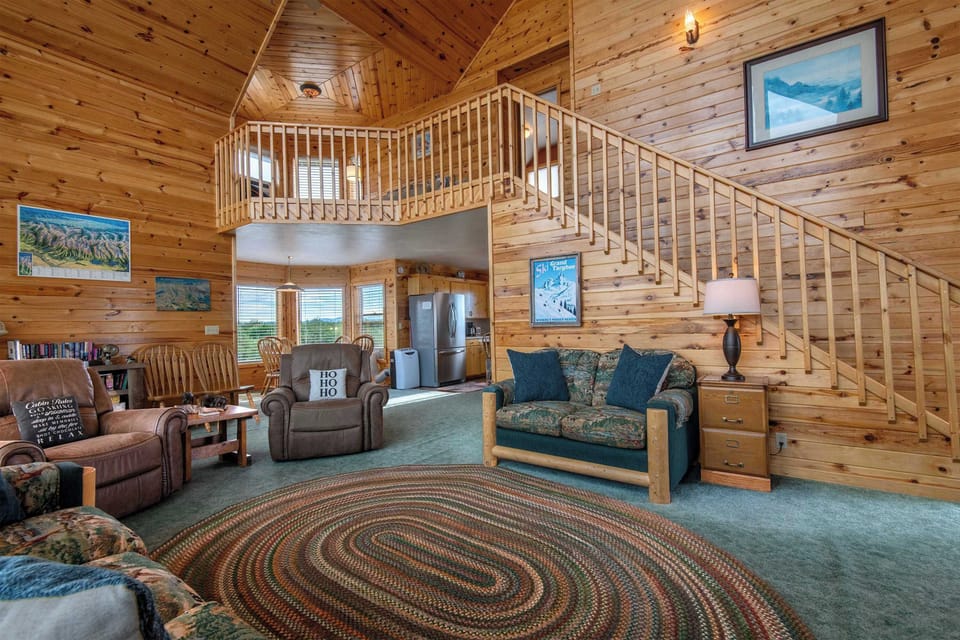 Vaulted ceilings and a cozy gathering area make this living room the heart of the cabin — plenty of room to sprawl out after a big day in the mountains.
